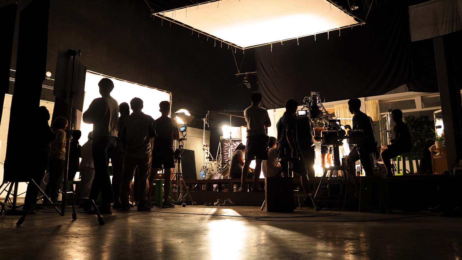 Professional video production studio with crew and cinematic lighting